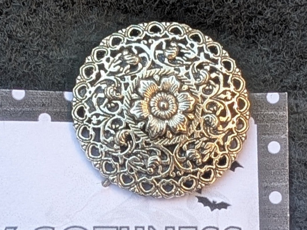 Hand made round decorative floral silver-tone metal lapel pin.