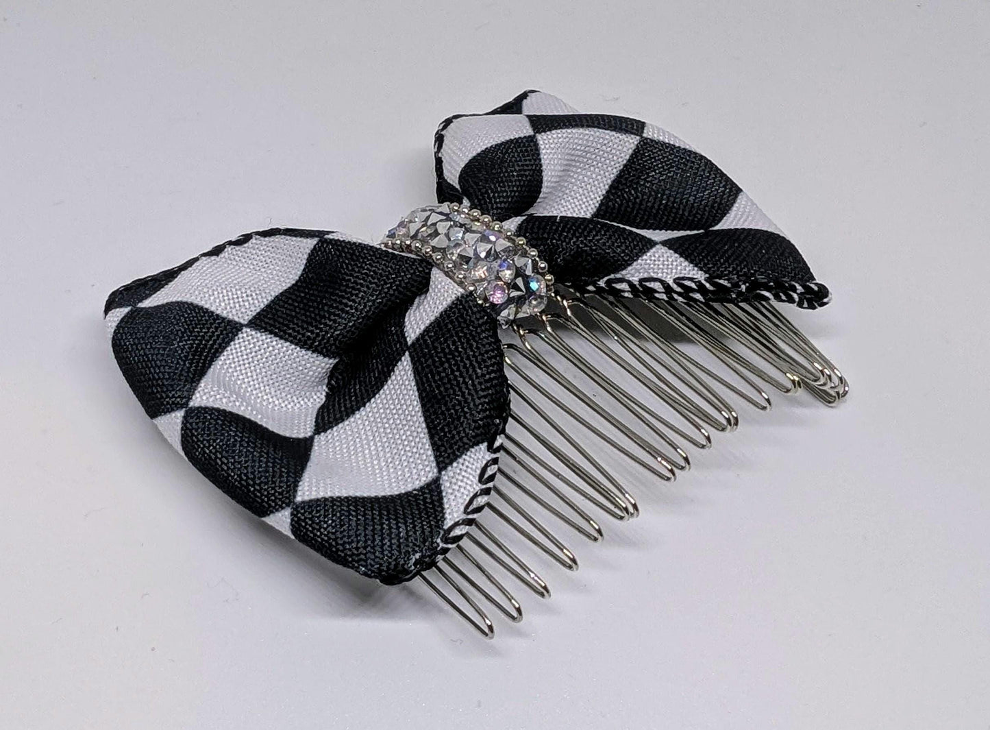 Black + White large check hair bow on a metal comb with rhinestones centre. Goth rockabilly party accessory fun punk gift ladies or girls