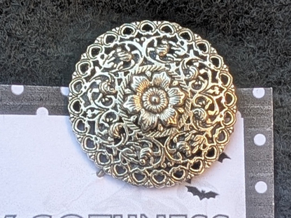 Hand made round decorative floral silver-tone metal lapel pin.